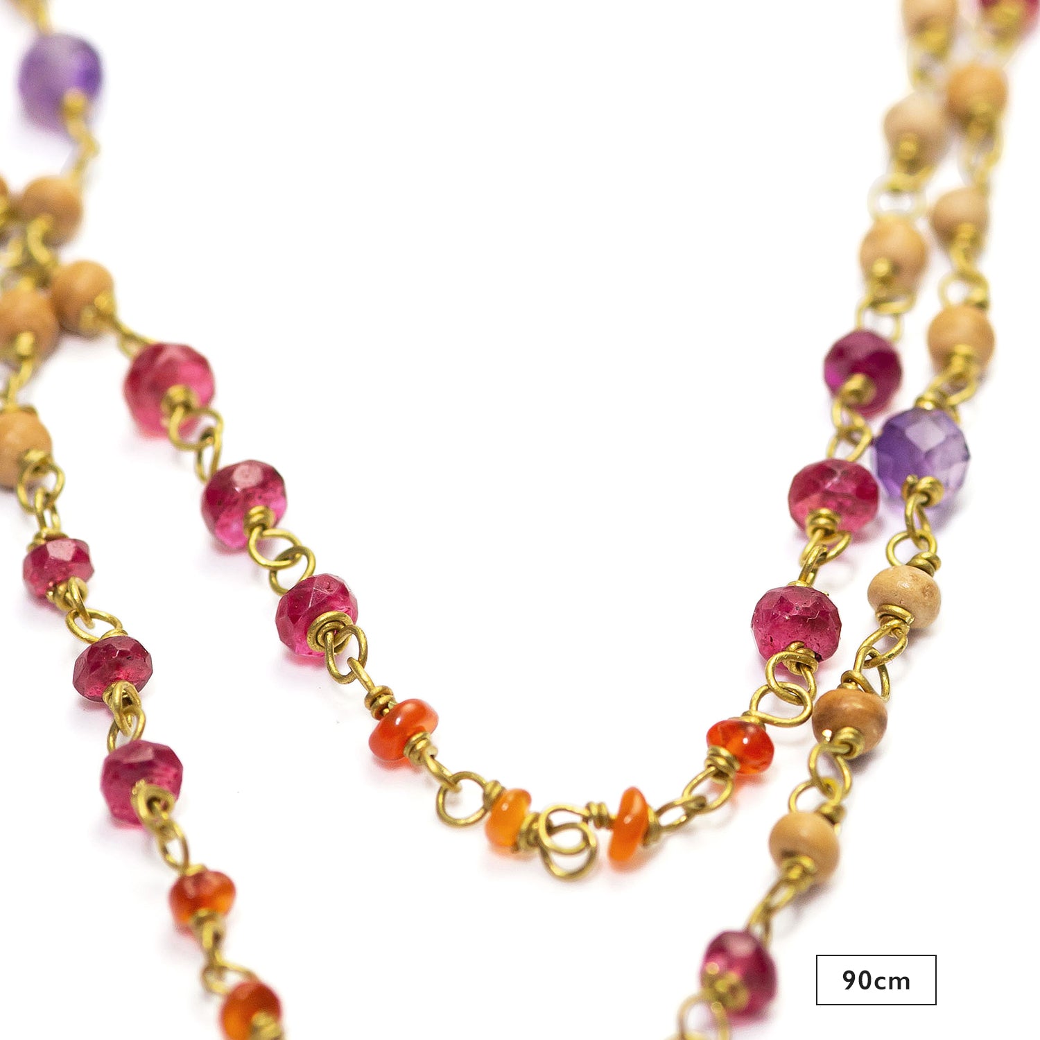 Detail of the 90cm gemstone necklace "Prana" made of high-quality gold-plated sterling silver with rubies, carnelians, amethysts, and sandalwood by Eternal Bliss