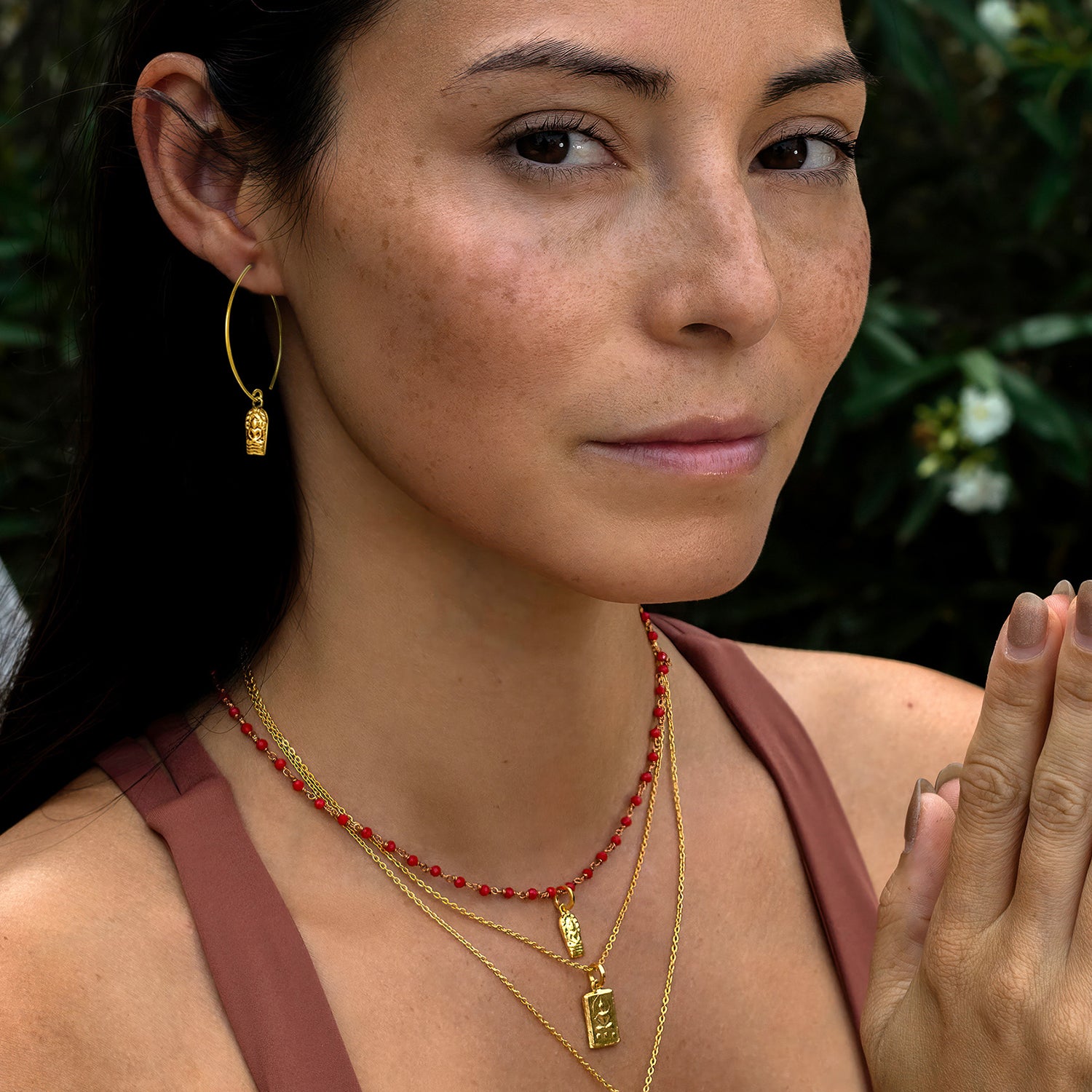 Detailaufnahme: Die Yogalehrerin Steffi trägt ein Buddha Anhänger mini vergoldet aus Sterling Silber zusammen mit aderem hochwertigen Schmuck von ETERNAL BLISS - Spiritueller Schumuck